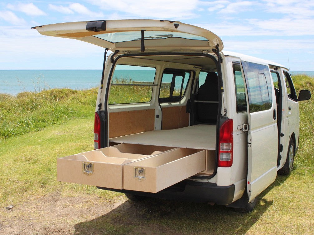 2018 Toyota Hiace ZL, white, rear view, liftgate open, vanequip birch plywood van false floor and drawers installed.
